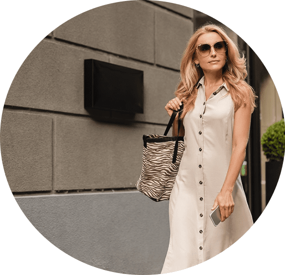 A woman in sunglasses and a white dress